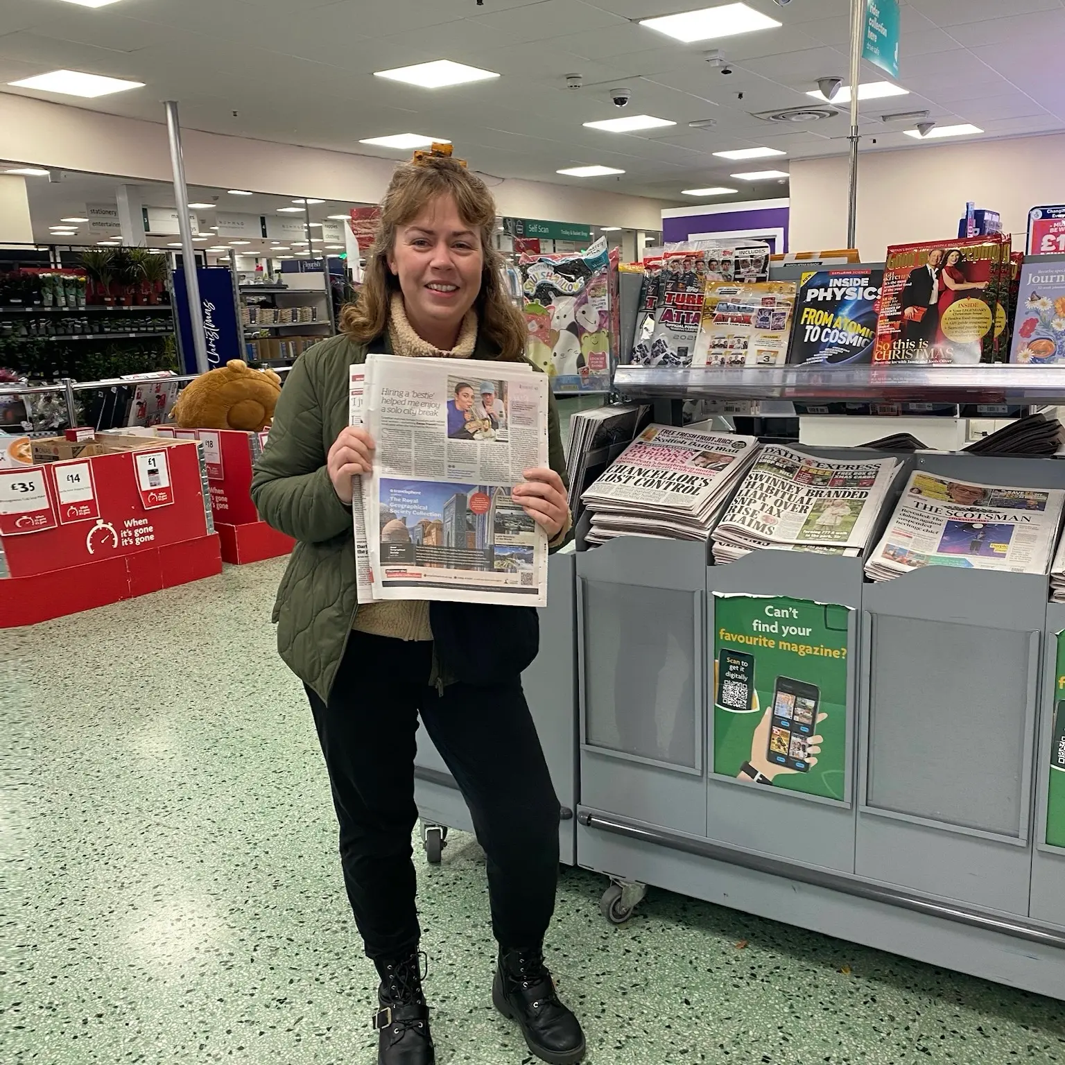Freelance travel writer Emma Truscott holding a newspaper spread now offers power hours to other aspiring travel writers