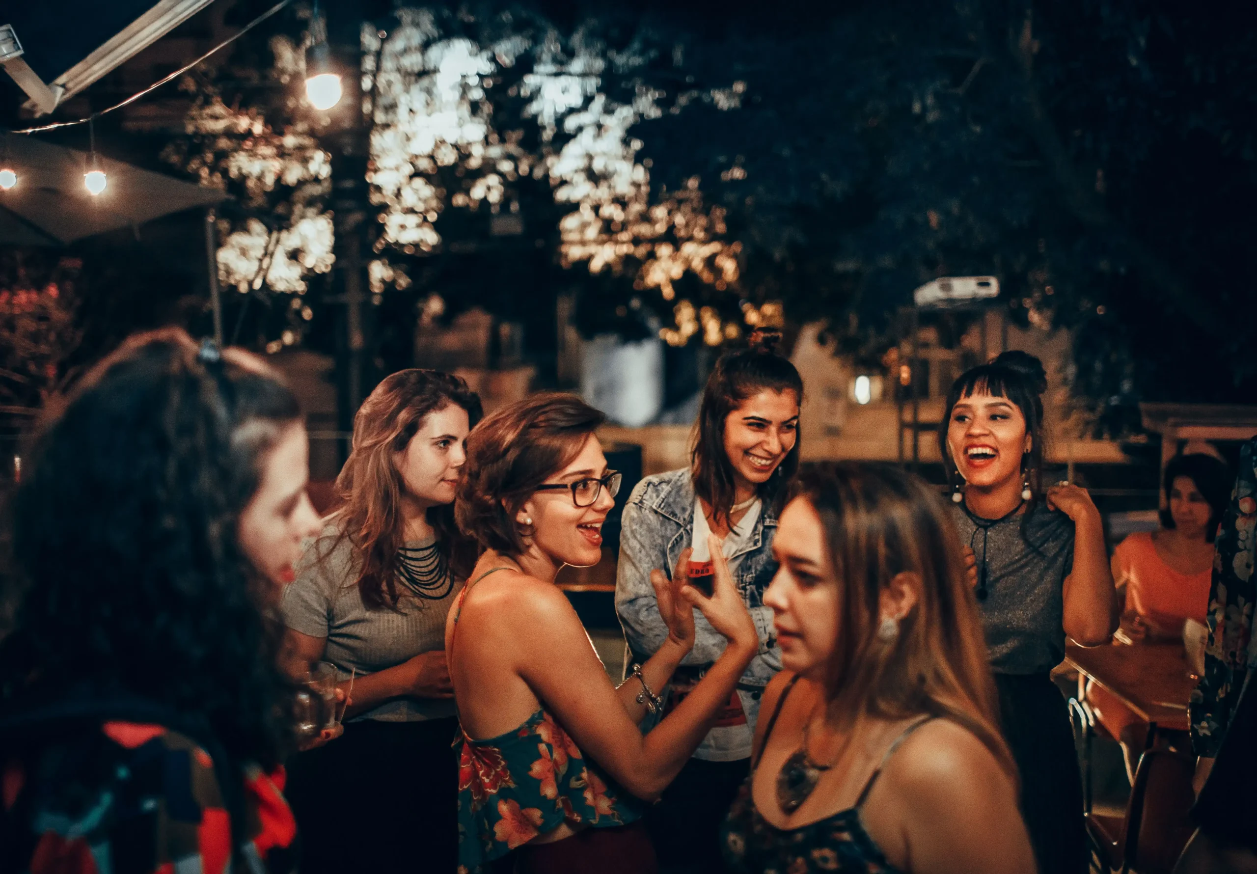 A vibrant group of young adults enjoying a lively evening party while making female friends in London