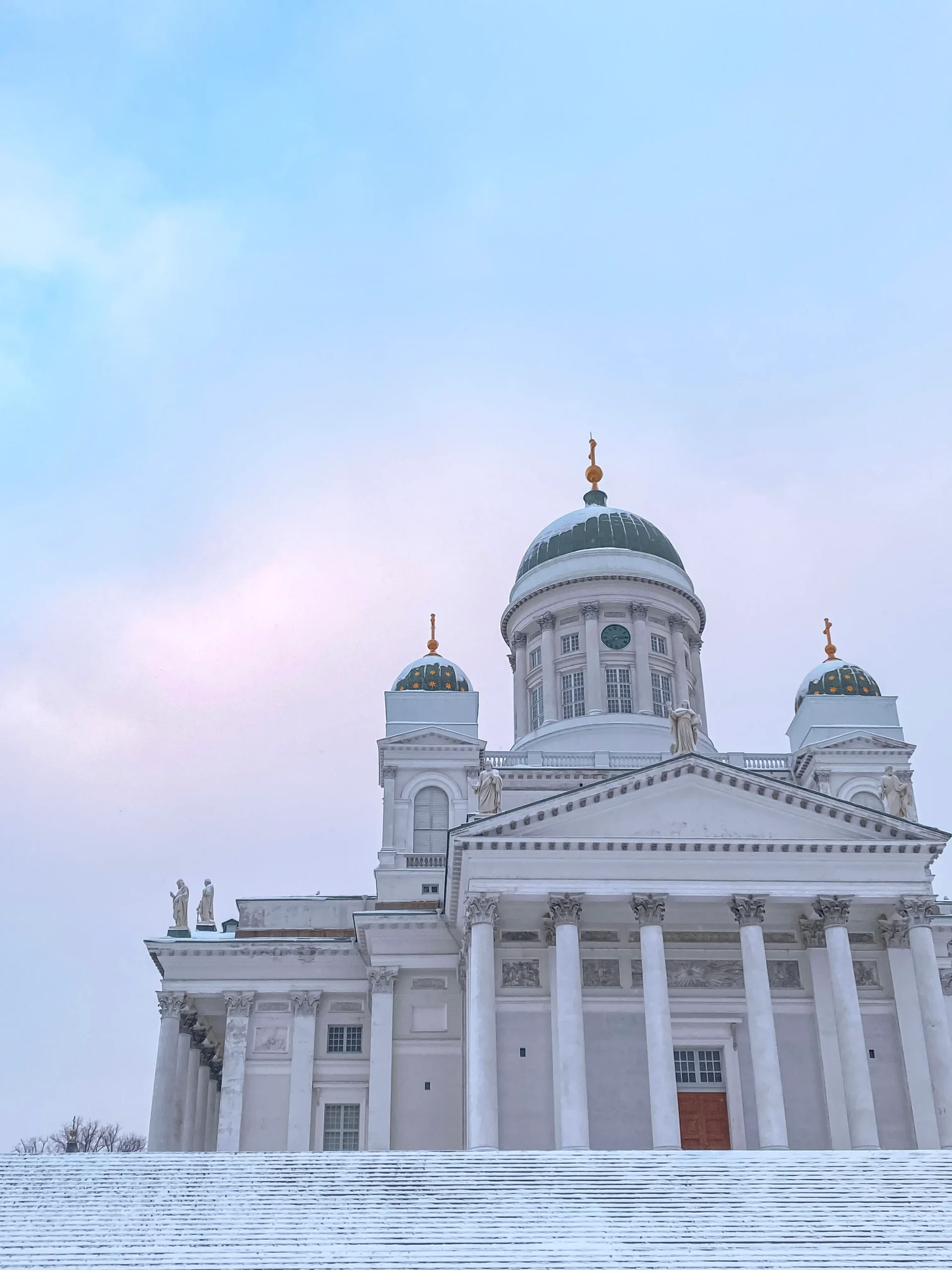 Helsinki Cathedral covered in snow during winter.